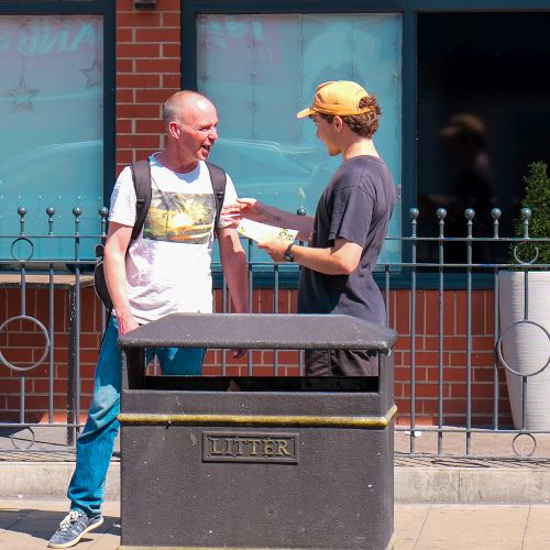 A Cooperation Hull volunteer talking to a man on the street